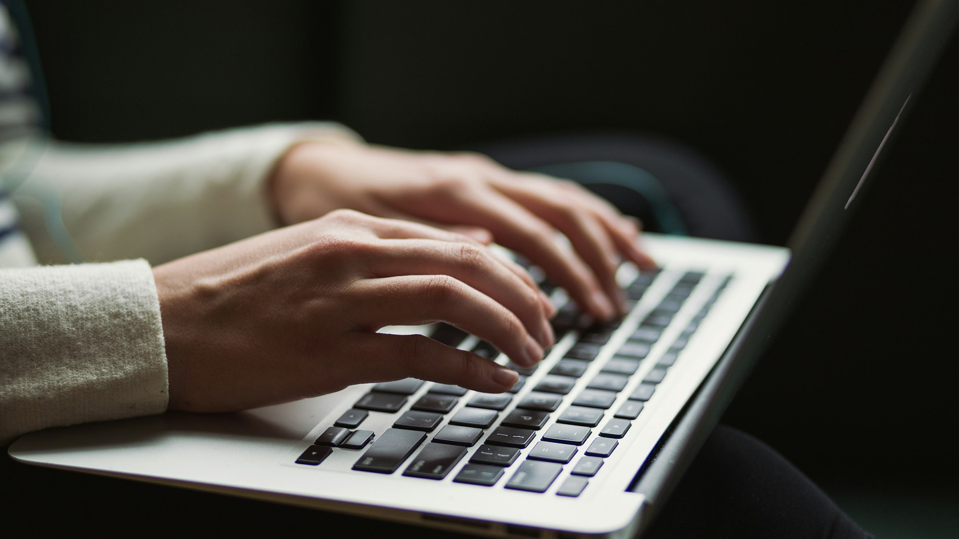 Someone typing on a laptop